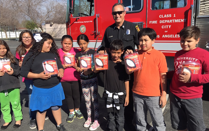 Students show their free smoke alarms off
