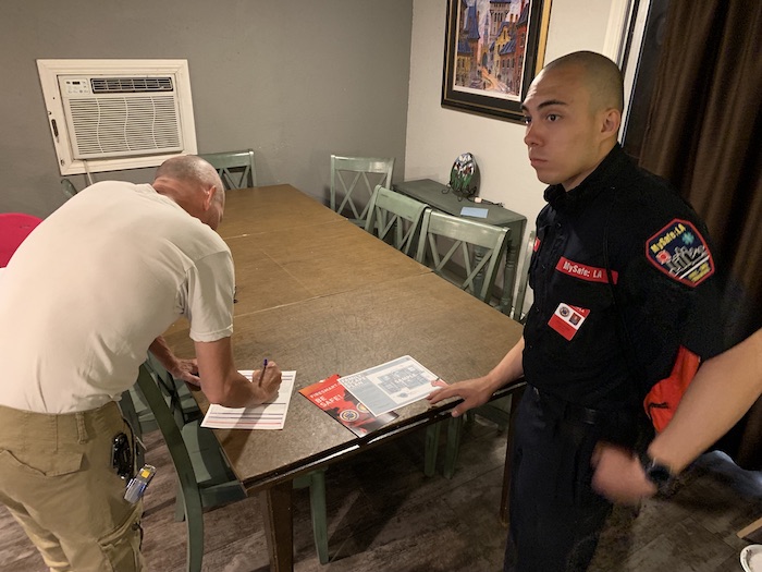 MySafe:LA educator Adam Mendiola works with a homeowner during fire safety canvassing with MySafe:LA