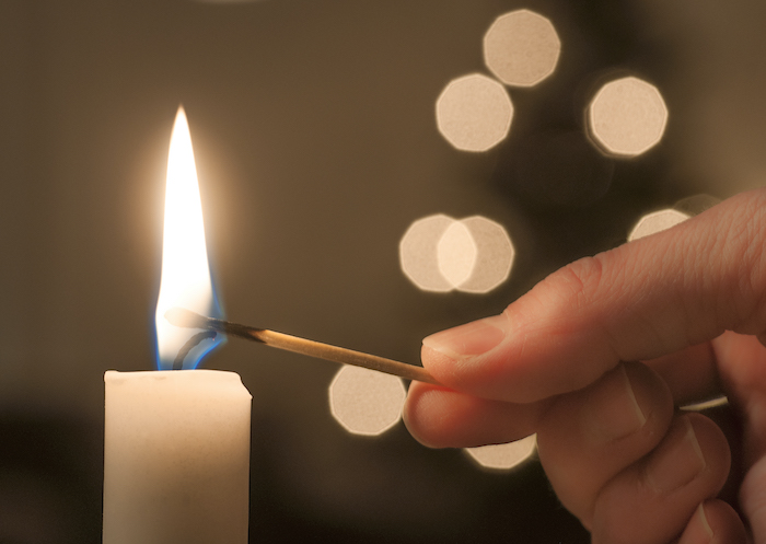 a match being used to light a candle