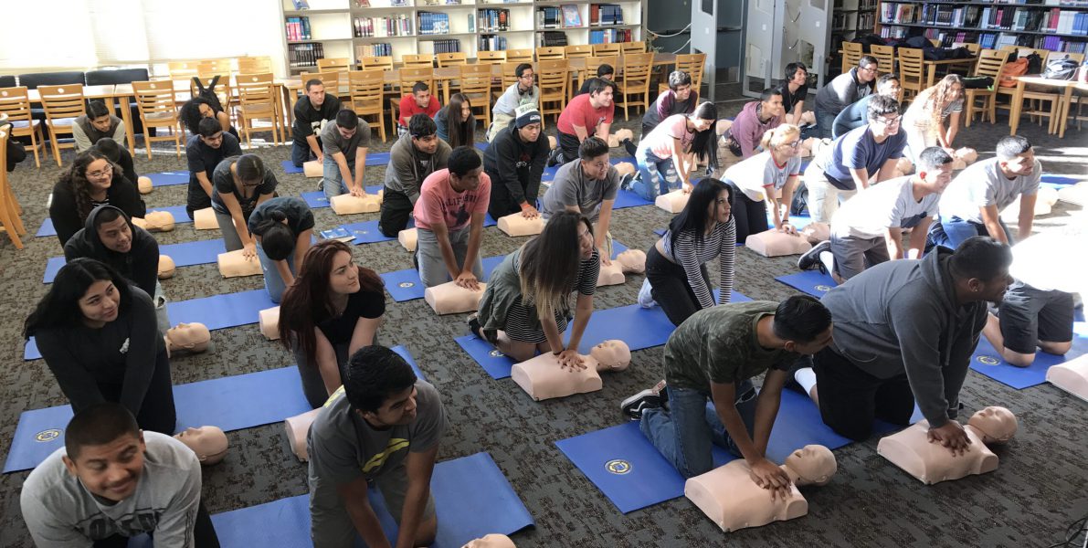 High school students performing CPR exercises